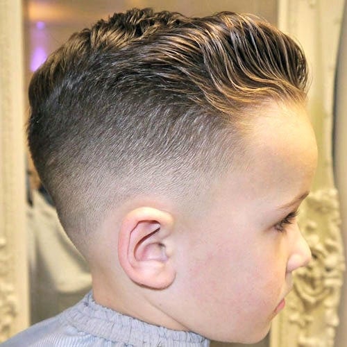 Low Bald Fade with Wavy Brushed Back Hair