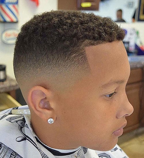 Tight Curls with a Mid Bald Fade